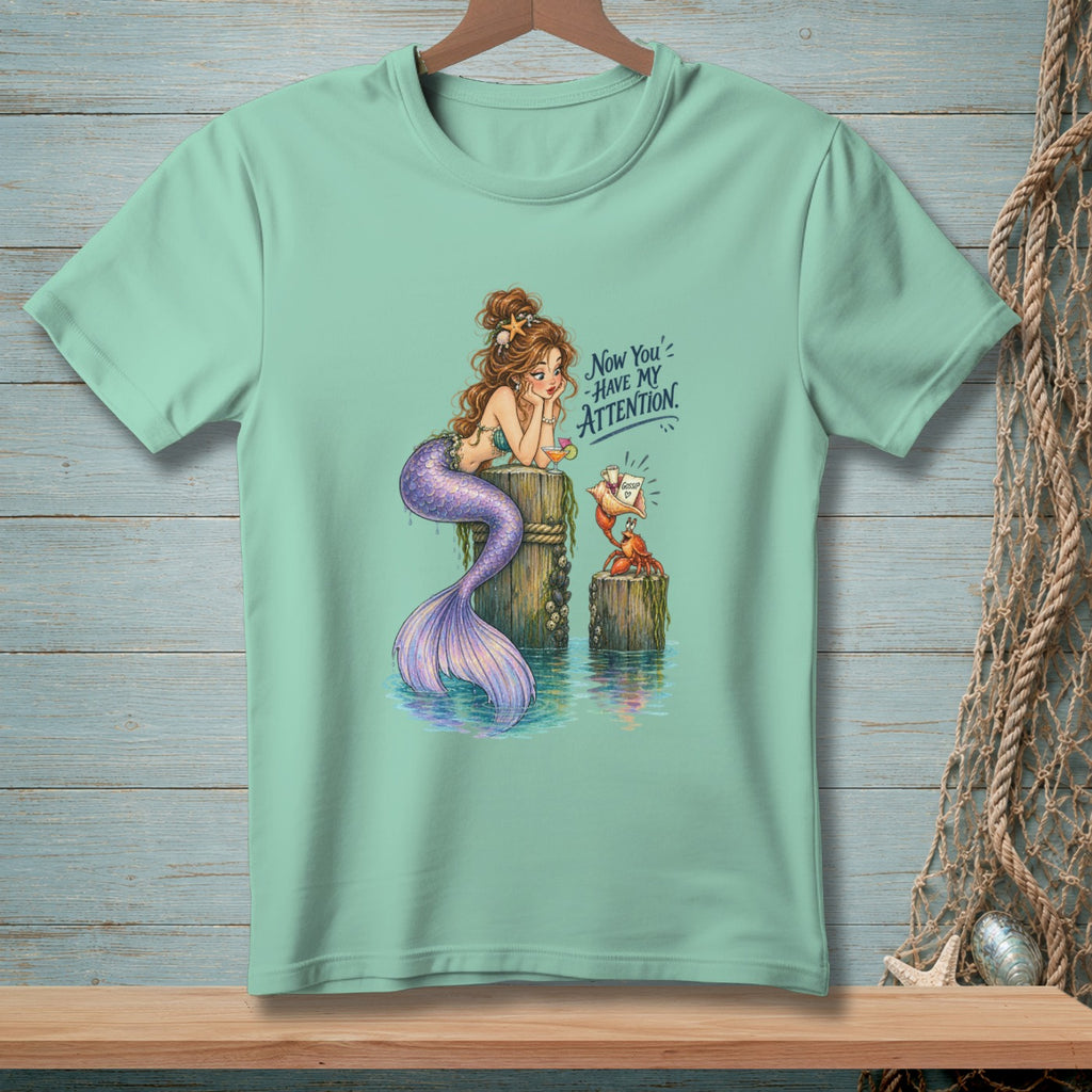 Mermaid resting on a post with a crab holding a gossip seashell.