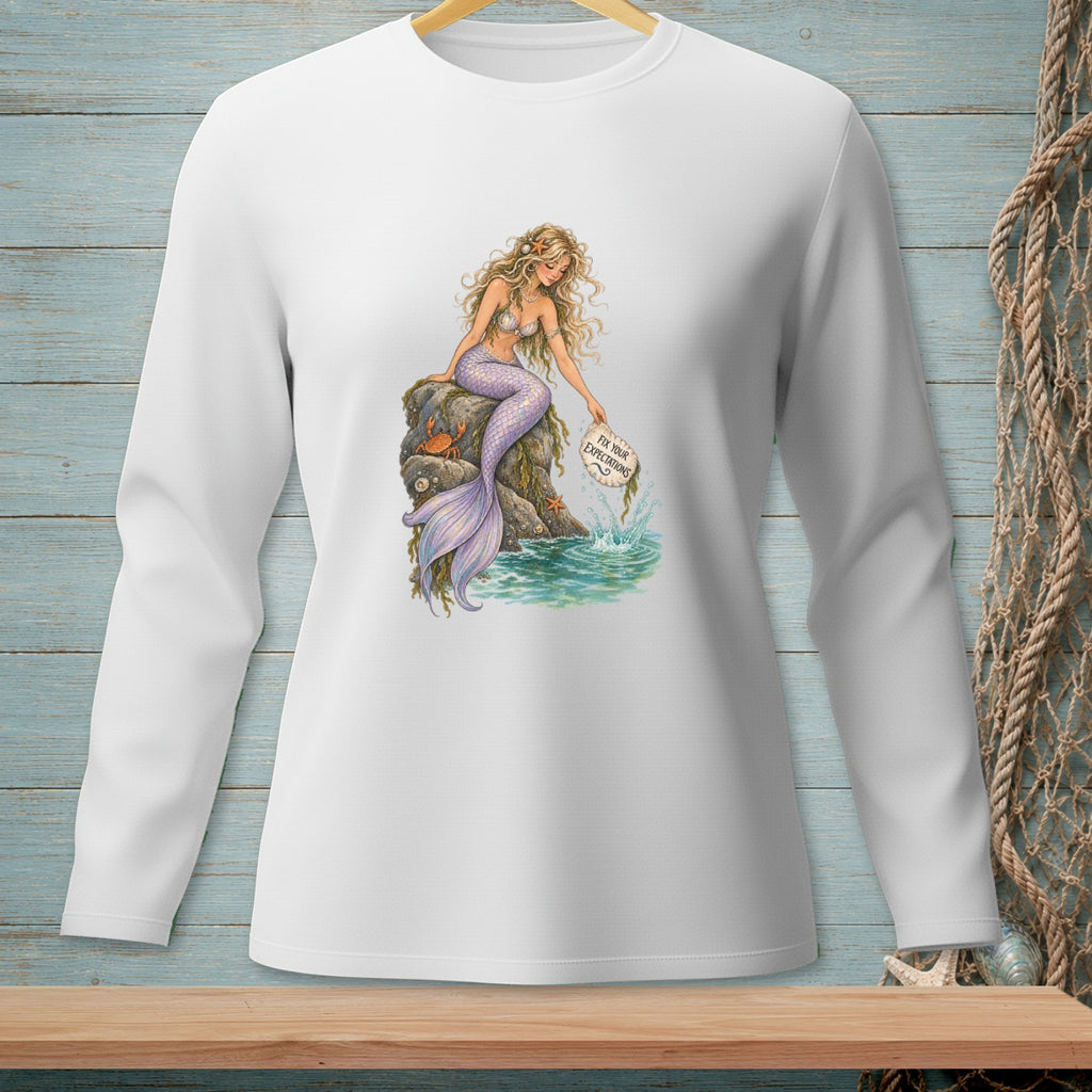 Mermaid with purple tail sits on rock, holding a sign that says "Fix Your Expectations."