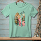 Mint t-shirt with mermaid, crab, and text "And yet, here you are."
