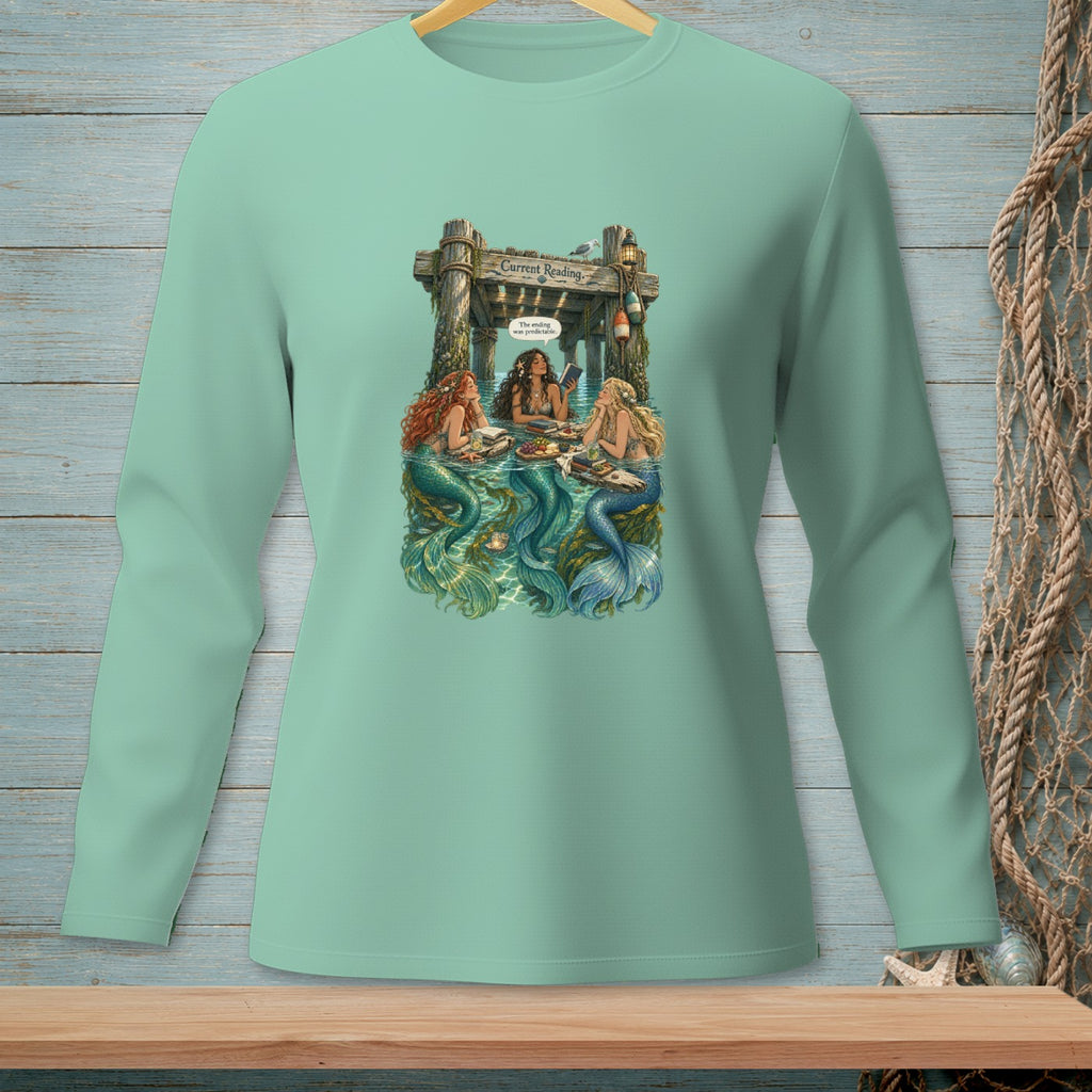 Three mermaids sit by a dock reading, with text "Current Reading."