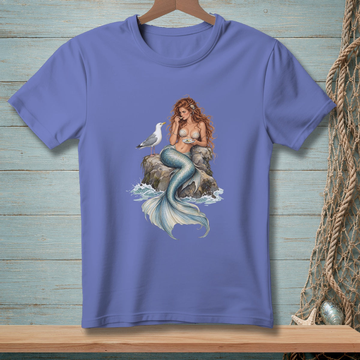 Mermaid with seagull sitting on a rock, detailed illustration on a t-shirt.