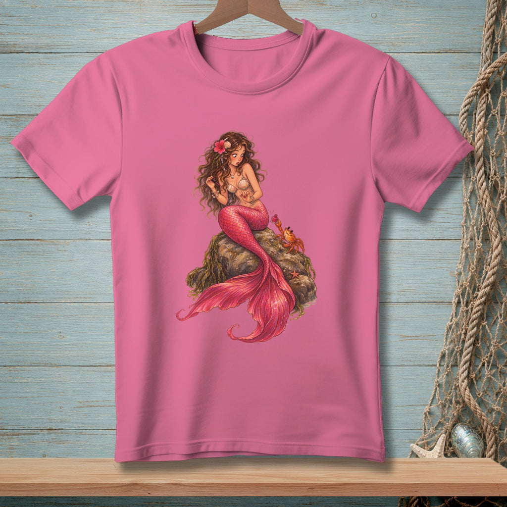 Pink t-shirt with a detailed illustration of a mermaid and a crab sitting on a rock.
