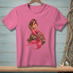 Pink t-shirt with a detailed illustration of a mermaid and a crab sitting on a rock.