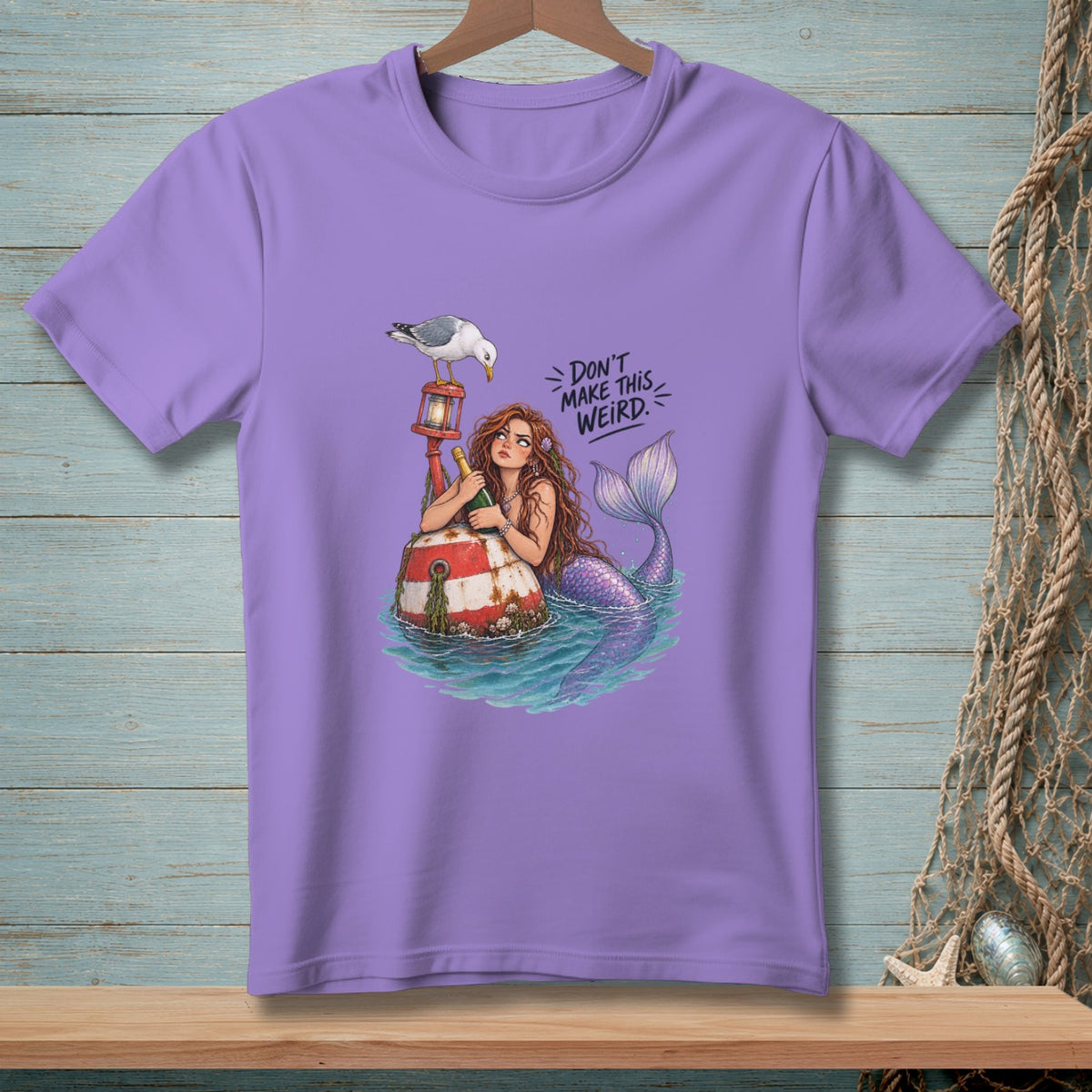 Purple t-shirt with mermaid, seagull, and text that reads "Don't make this weird."