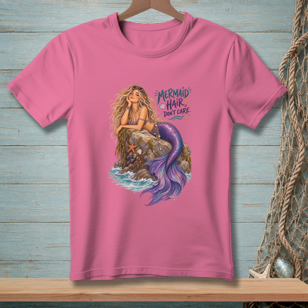 Pink t-shirt with a mermaid design and text "Mermaid Hair, Don't Care."