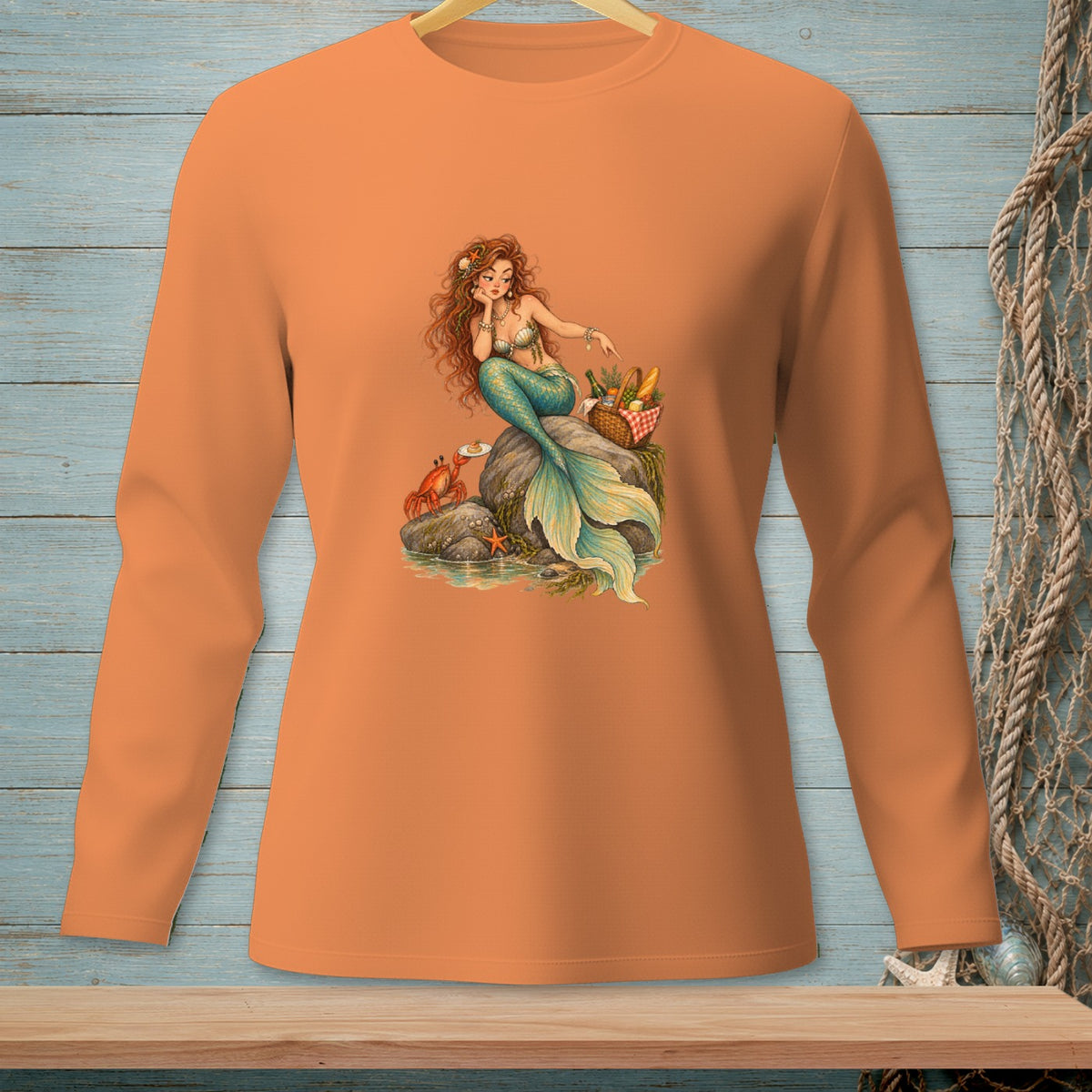 Mermaid with crab and picnic basket sitting on a rock.