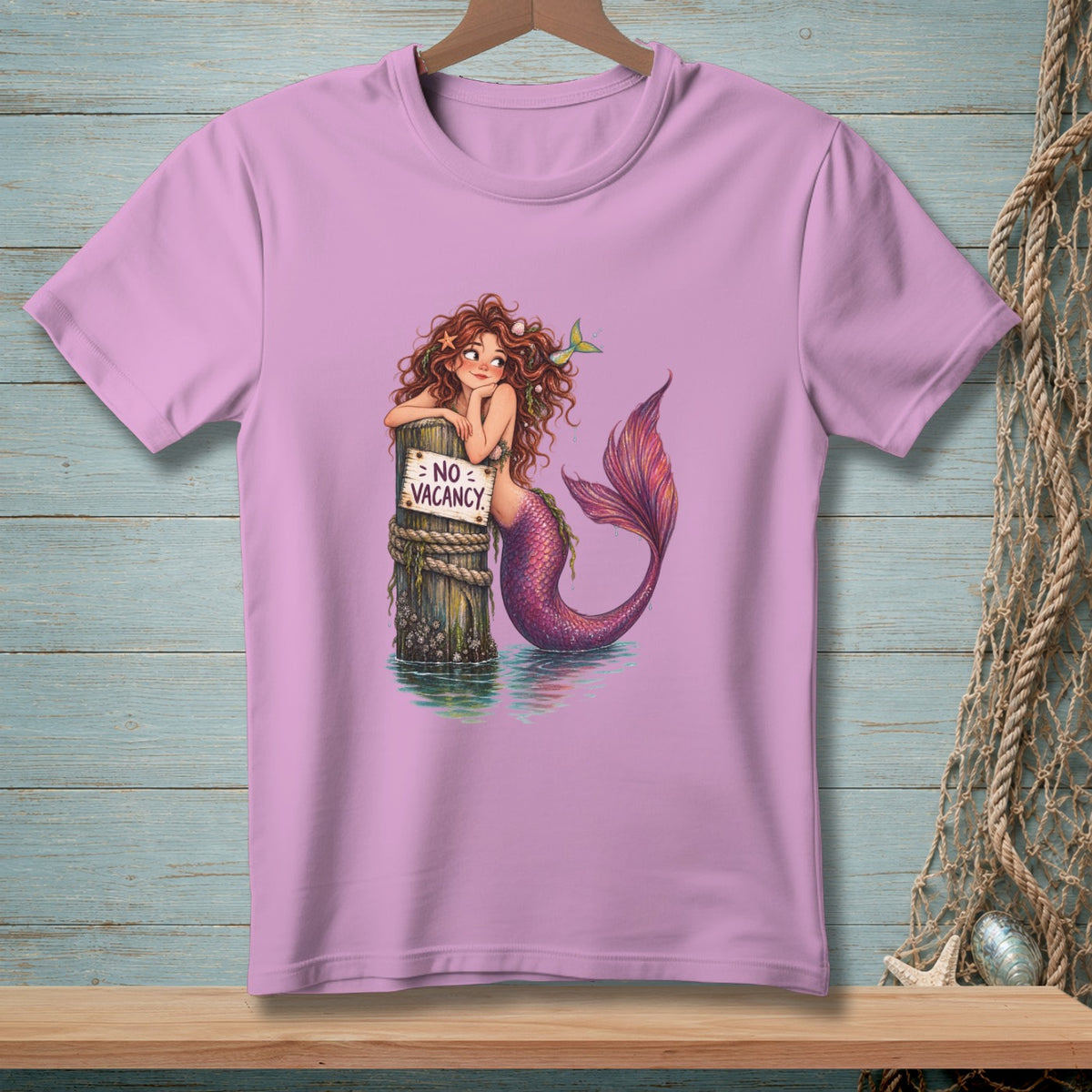 Mermaid with purple tail leans on post with "NO VACANCY" sign.