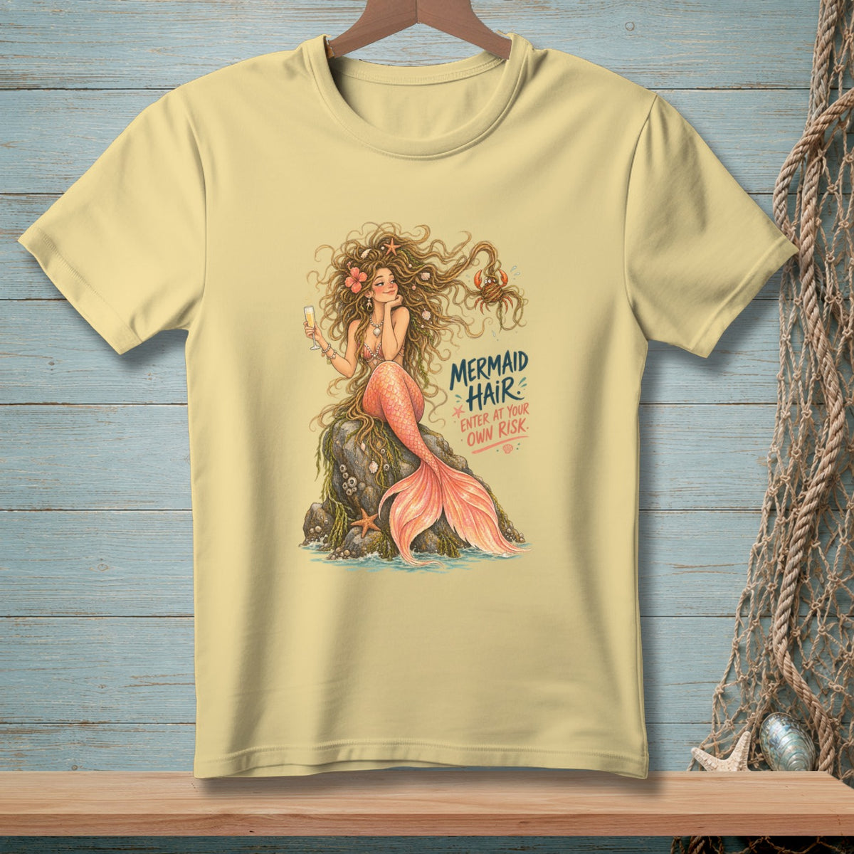 Light yellow t-shirt with mermaid graphic and text "MERMAID HAIR ENTER AT YOUR OWN RISK."