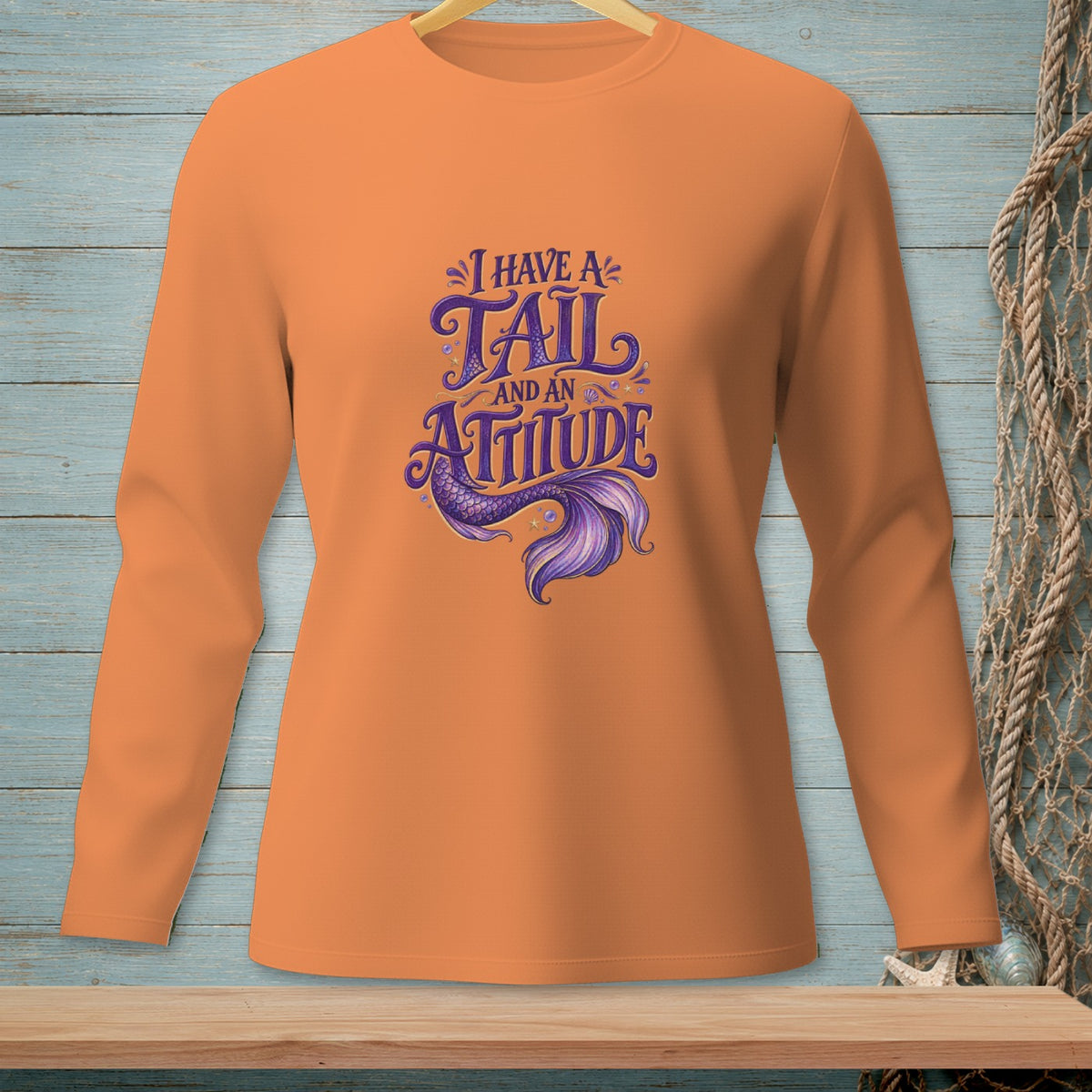 Orange long sleeve shirt with "I Have A Tail And An Attitude" mermaid graphic.