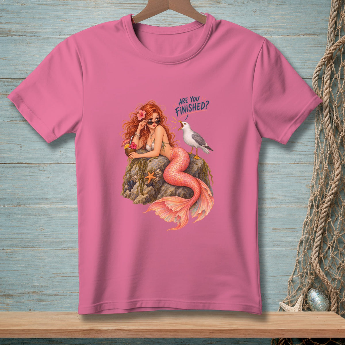 Pink t-shirt with illustration of a mermaid and a seagull asking "Are you finished?".