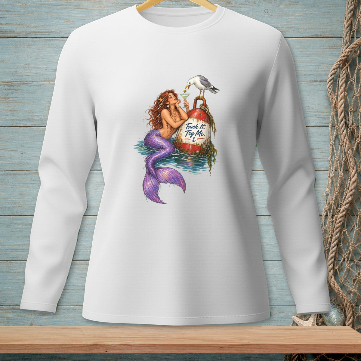 Mermaid with purple tail sits on a buoy with text, a seagull perched above.