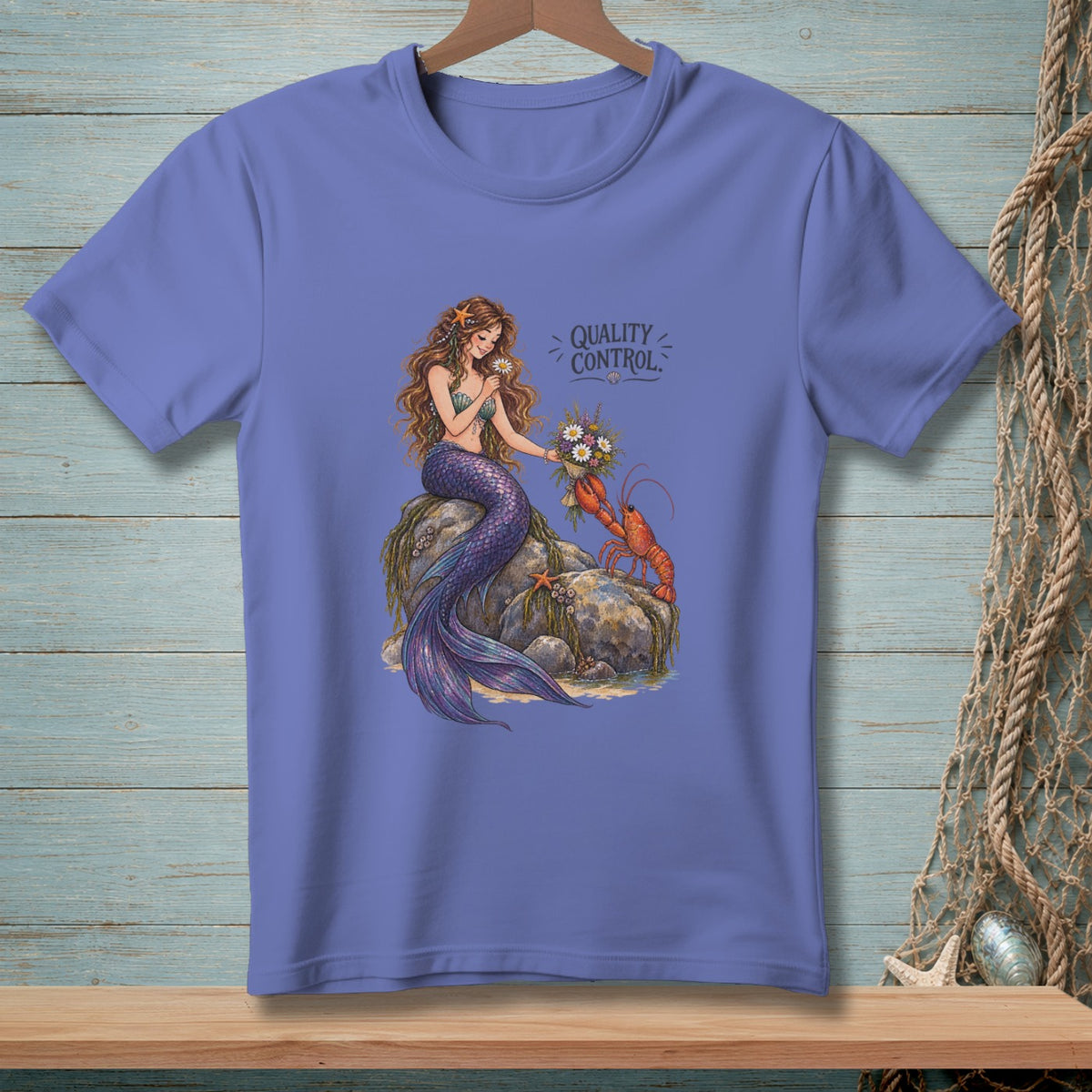 Mermaid and lobster with flowers, text "Quality Control" printed on purple shirt.