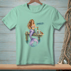 Mermaid on dock with wine and crab, text "HANDLED".