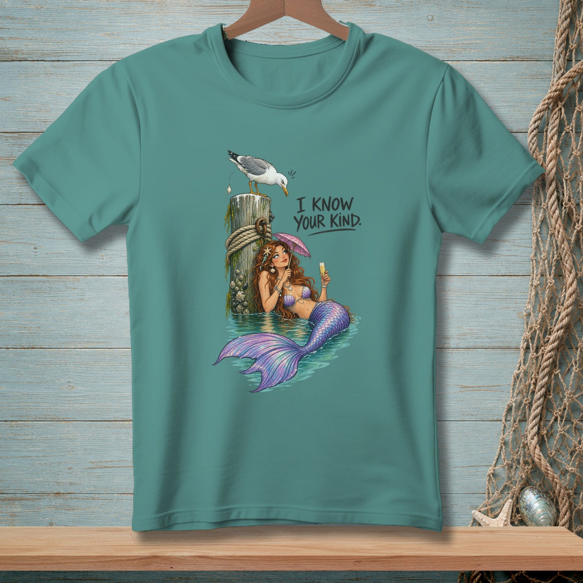 Mermaid with umbrella and drink, a seagull perches on a post, with text "I KNOW YOUR KIND."