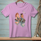 Pink t-shirt with two mermaids and a seagull illustration.