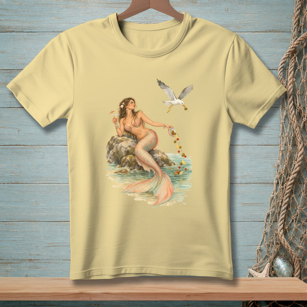Light yellow t-shirt with a graphic of a mermaid and a seagull by the water.