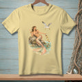 Light yellow t-shirt with a graphic of a mermaid and a seagull by the water.