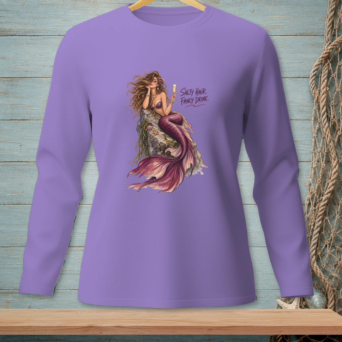Lavender long sleeve shirt with a mermaid graphic that reads "Salty Hair Fancy Drink."