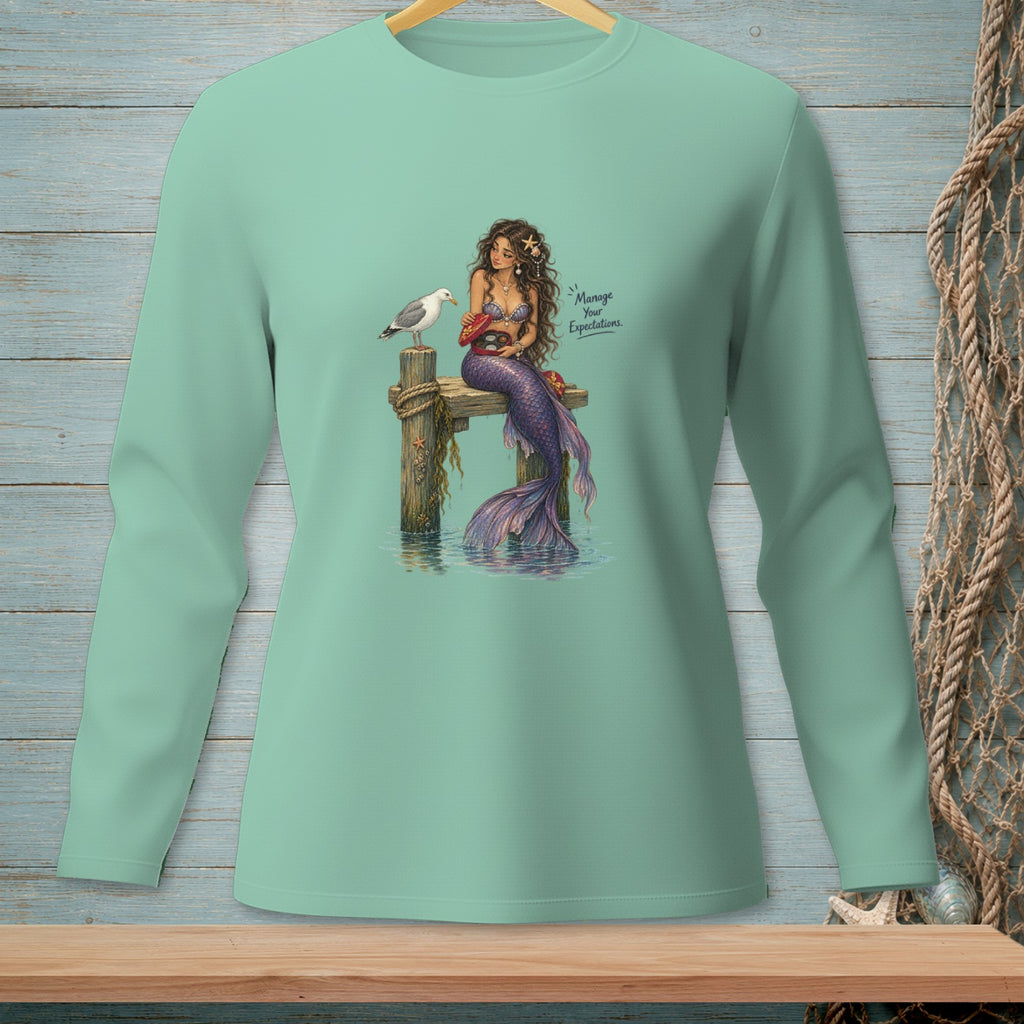 Mermaid sitting on a pier with a seagull and crab, text says "Manage Your Expectations."