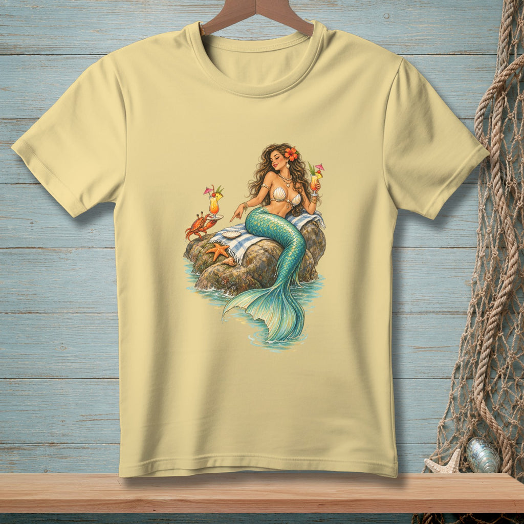 Light yellow t-shirt with mermaid, crab, starfish, and cocktails on a rock.