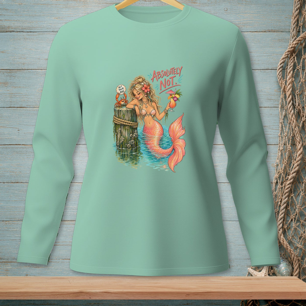 Mermaid with pink tail holds a cocktail, crab says "Act your age."
