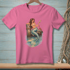 Pink t-shirt with a mermaid holding a cocktail on a dock with a crab.
