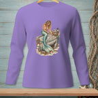 Purple long-sleeve shirt with a watercolor mermaid sitting on a weathered boat filled with shells.
