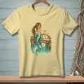 Mermaid reading a letter on a dock with a crab and cocktail.
