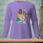 Three mermaids in a tub filled with fruit and flowers, on a purple long-sleeve shirt.