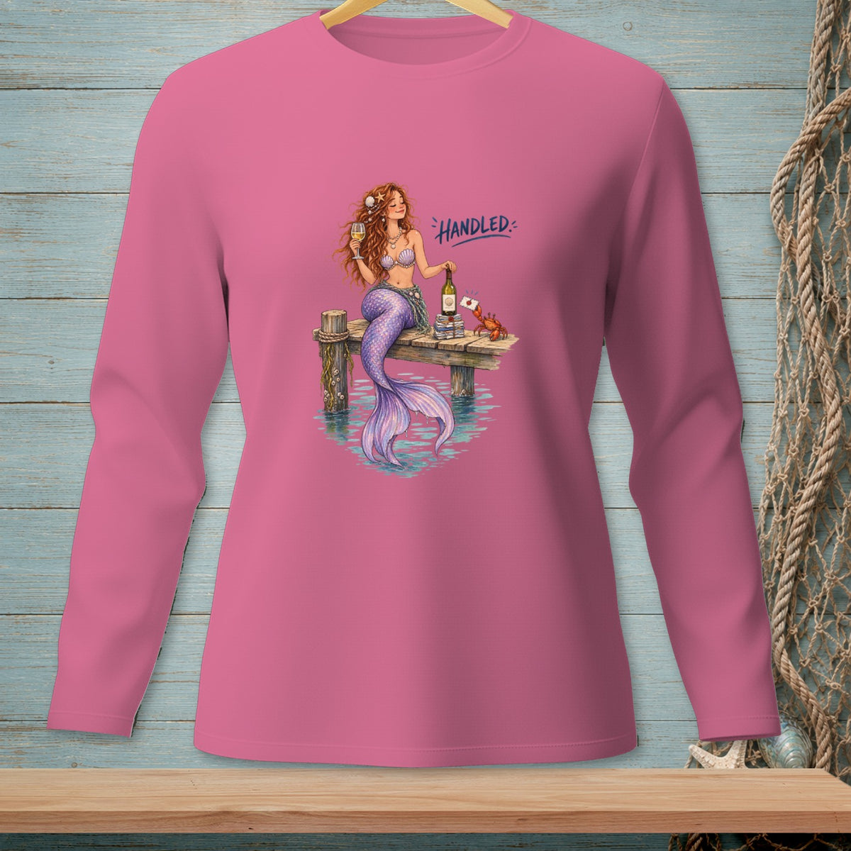 Mermaid with wine glass and bottle on pier, with text "HANDLED".