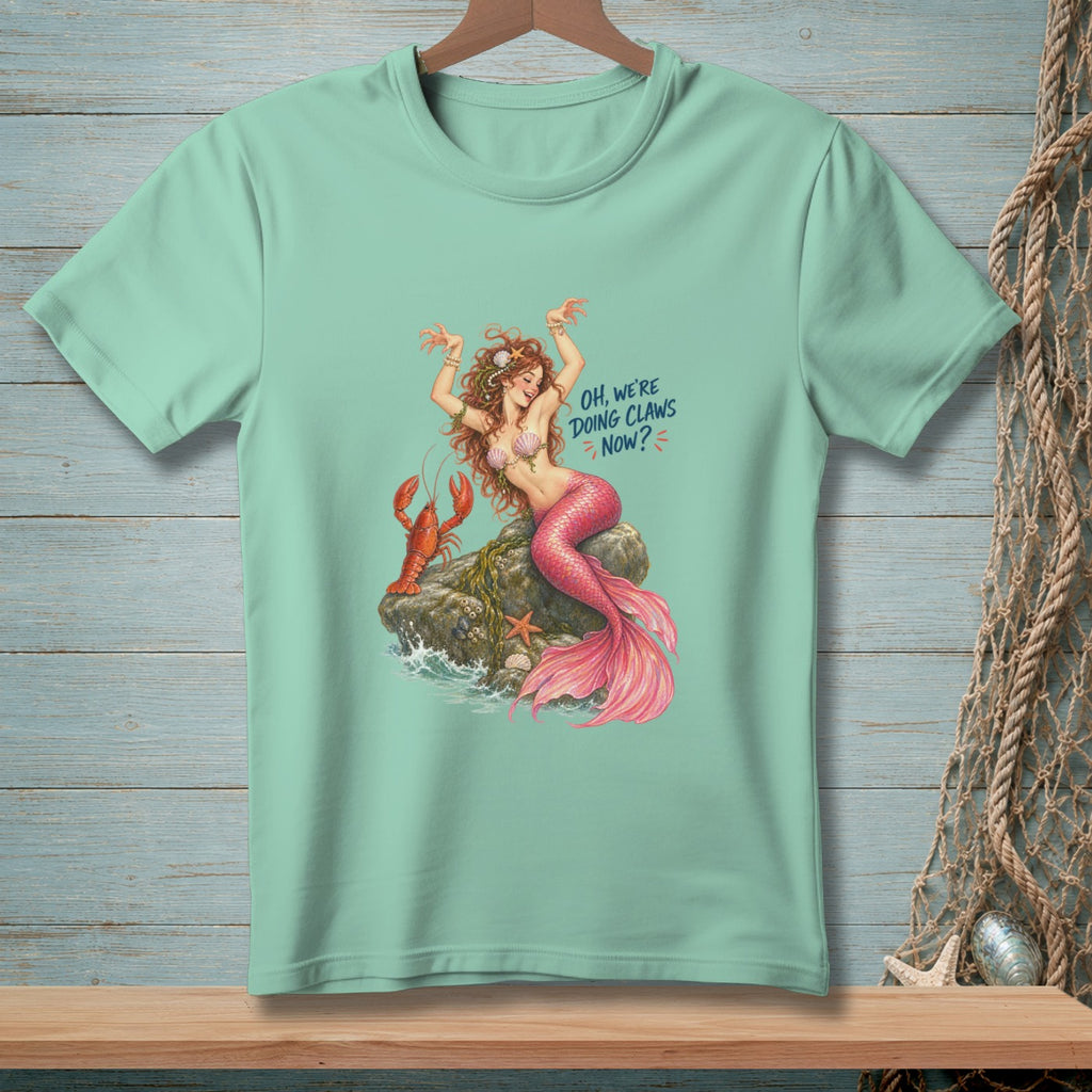 Mermaid with lobster on a rock, text "Oh, We're Doing Claws Now?"