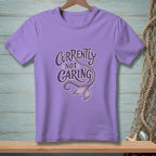 Purple t-shirt with "Currently Not Caring" text and mermaid tail graphic.
