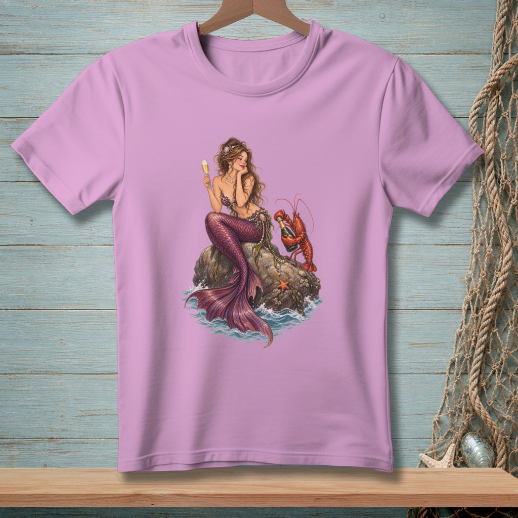 Mermaid with lobster holding a champagne bottle on a rock in the ocean.