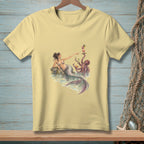 Mermaid and octopus sharing drinks on a rock at the water's edge.