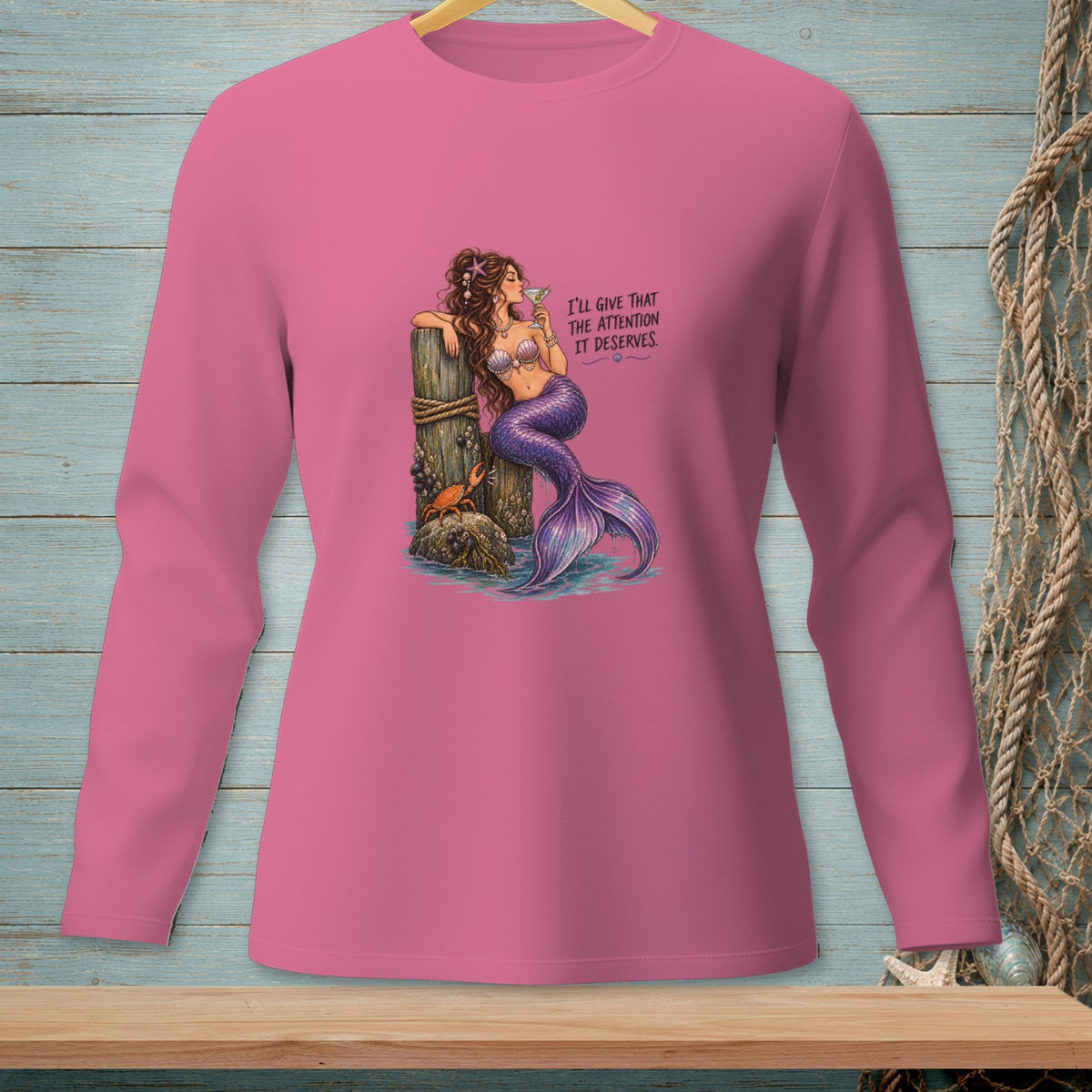 Mermaid with purple tail drinks martini and leans on post with crab, text says "I'll give that the attention it deserves."