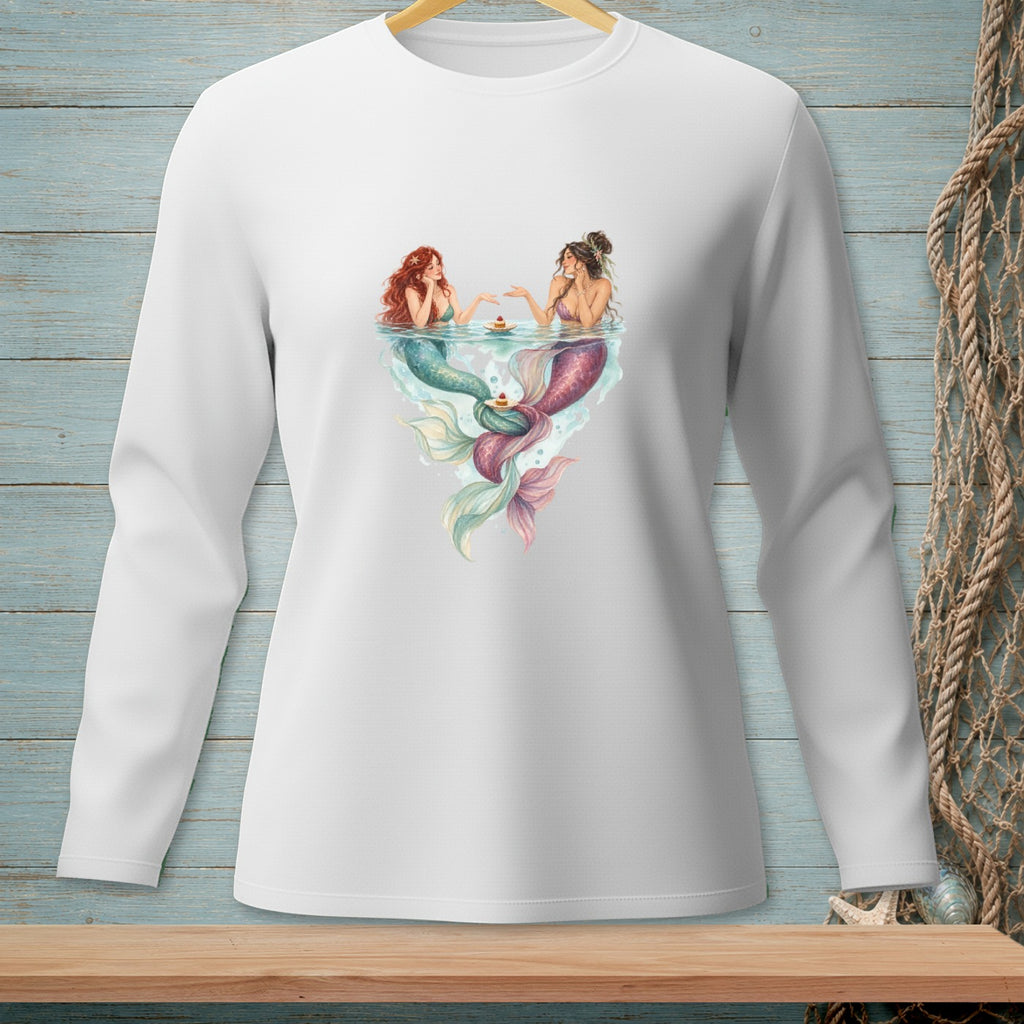 Two mermaids sharing cupcakes in water with colorful tails.