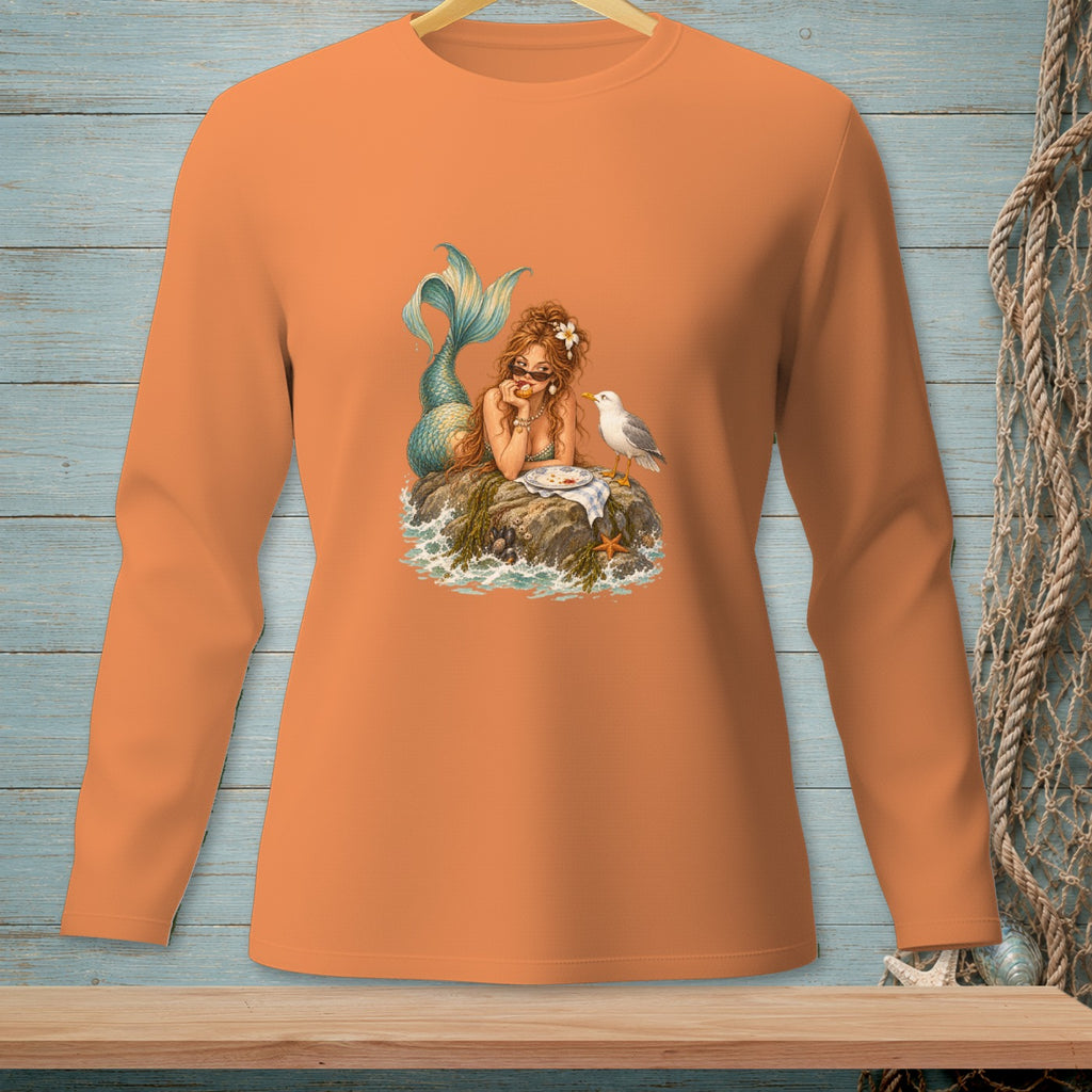 Mermaid on rock eating with seagull, on orange long-sleeve shirt.