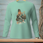 Mermaid sitting on a rock with a crab and a drink, on a teal shirt.