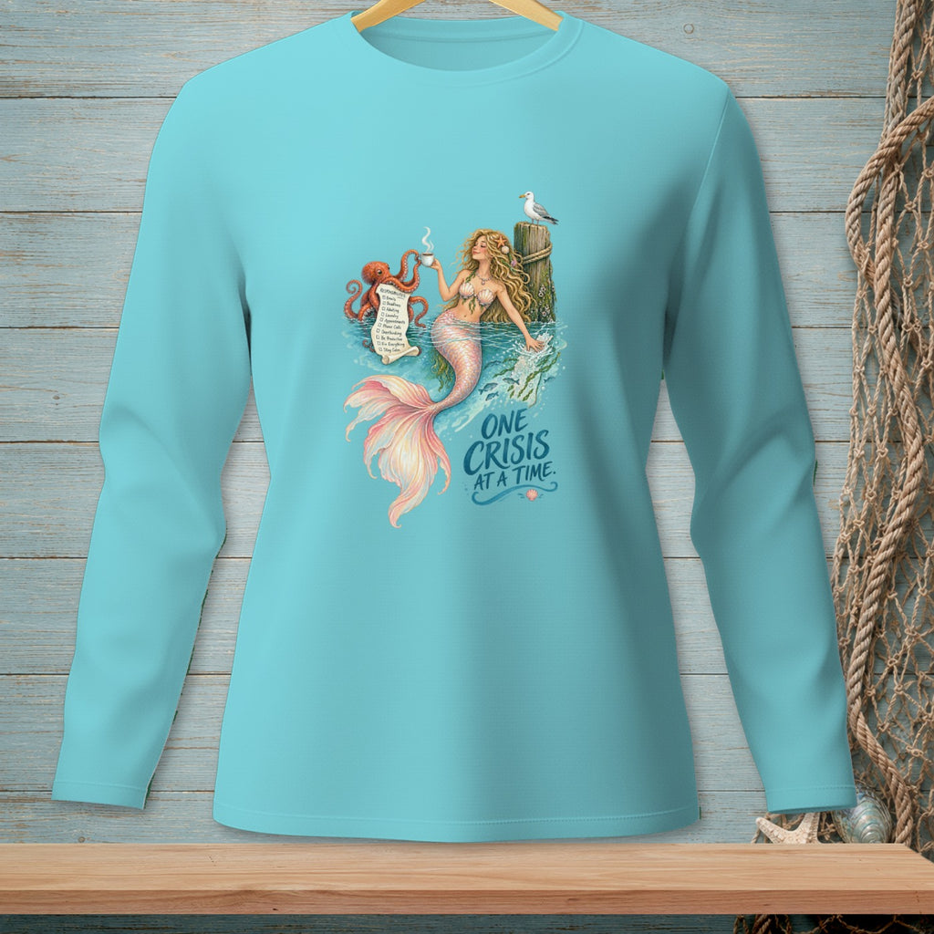 Mermaid holding coffee cup with octopus and text "One Crisis At A Time".