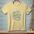 Light yellow t-shirt with "High Tide Higher Standards" text and mermaid tail graphic.