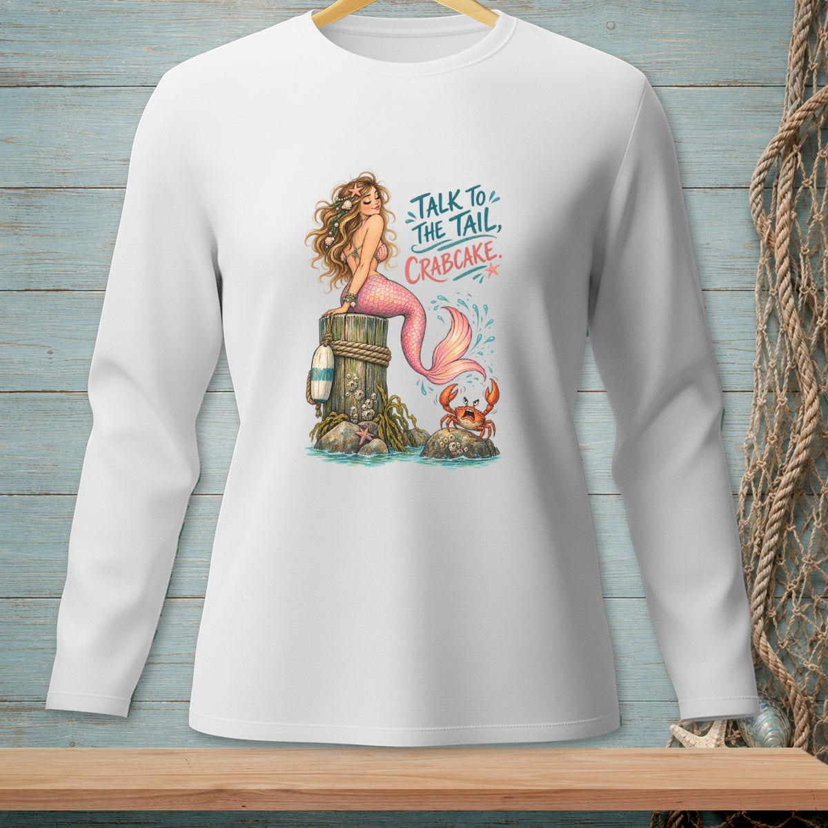 White long-sleeve shirt with a mermaid, crab, and "Talk to the Tail, Crabcake" text.