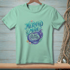 Light green t-shirt with "Mermaid Mode Do Not Disturb" graphic and mermaid tail.