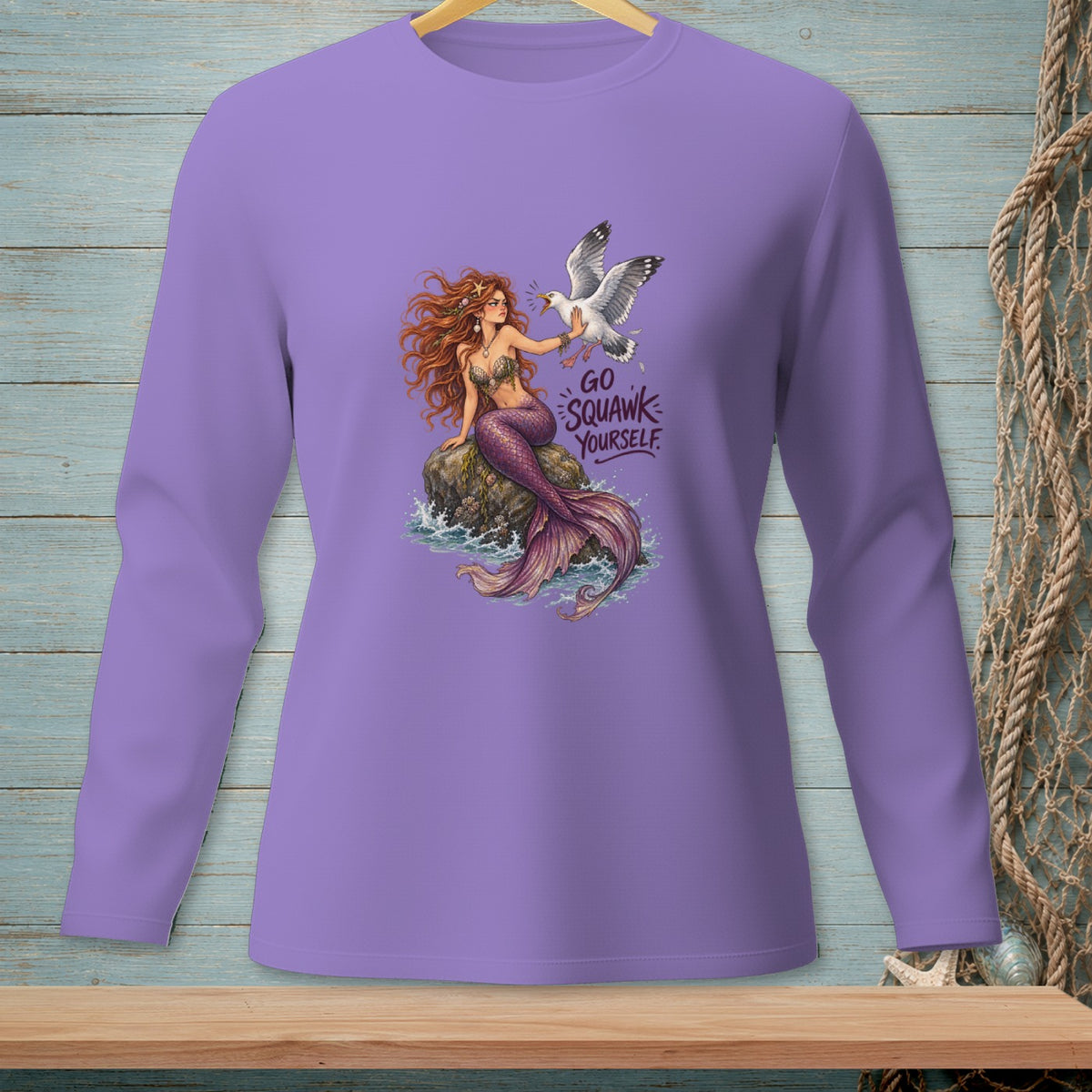 Mermaid with seagull and text "GO SQUAWK YOURSELF" on lavender shirt.