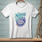 White t-shirt with "Mermaid Mode Do Not Disturb" text and mermaid tail design.