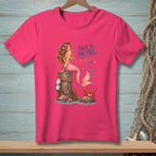 Pink t-shirt with mermaid and crab graphic and text "Talk to the tail, Crabcake."