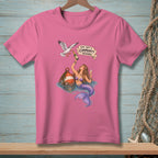 Pink t-shirt with mermaid, champagne, seagull, and "This isn't a community resource" text.