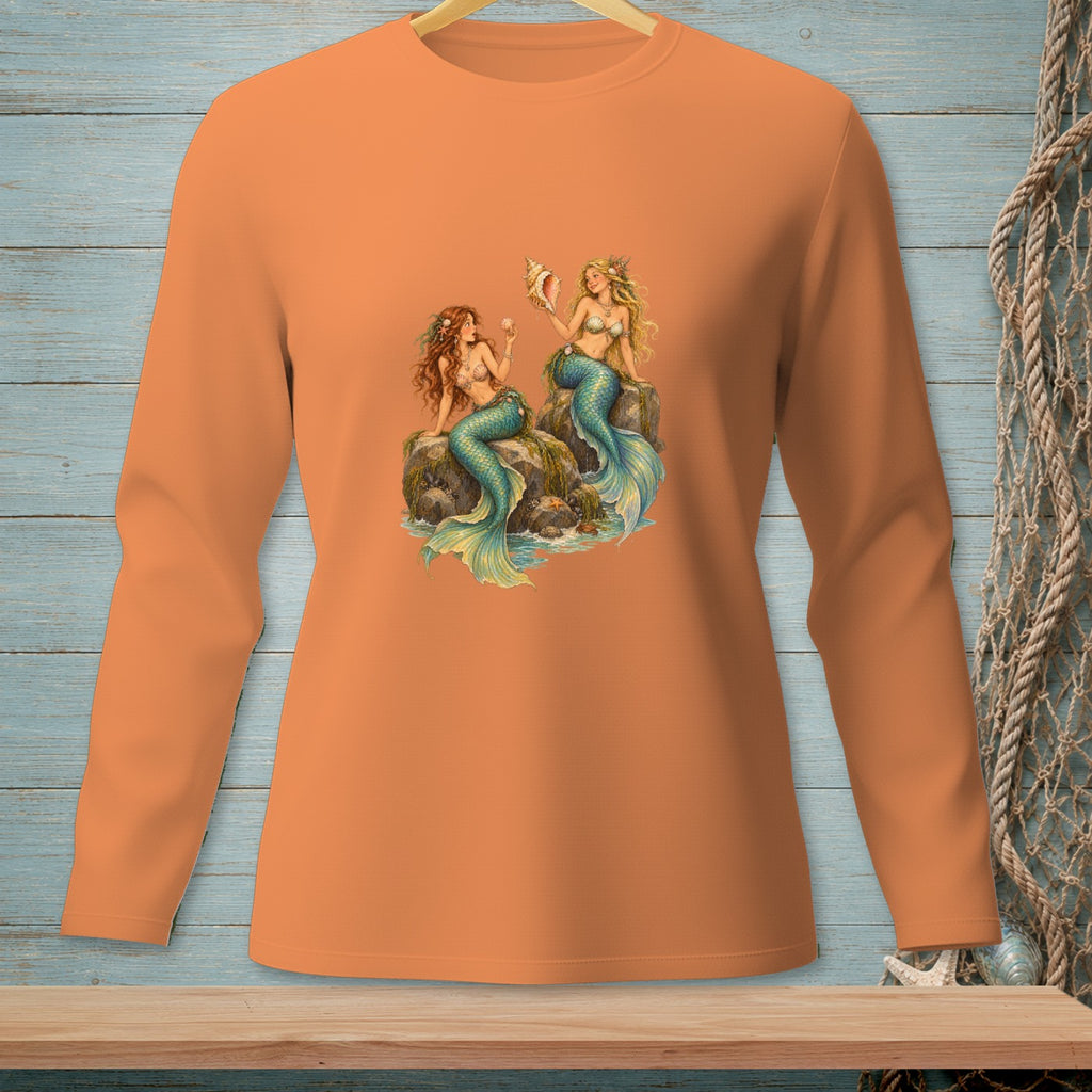 Orange long-sleeve shirt featuring two mermaids sitting on rocks with a seashell.