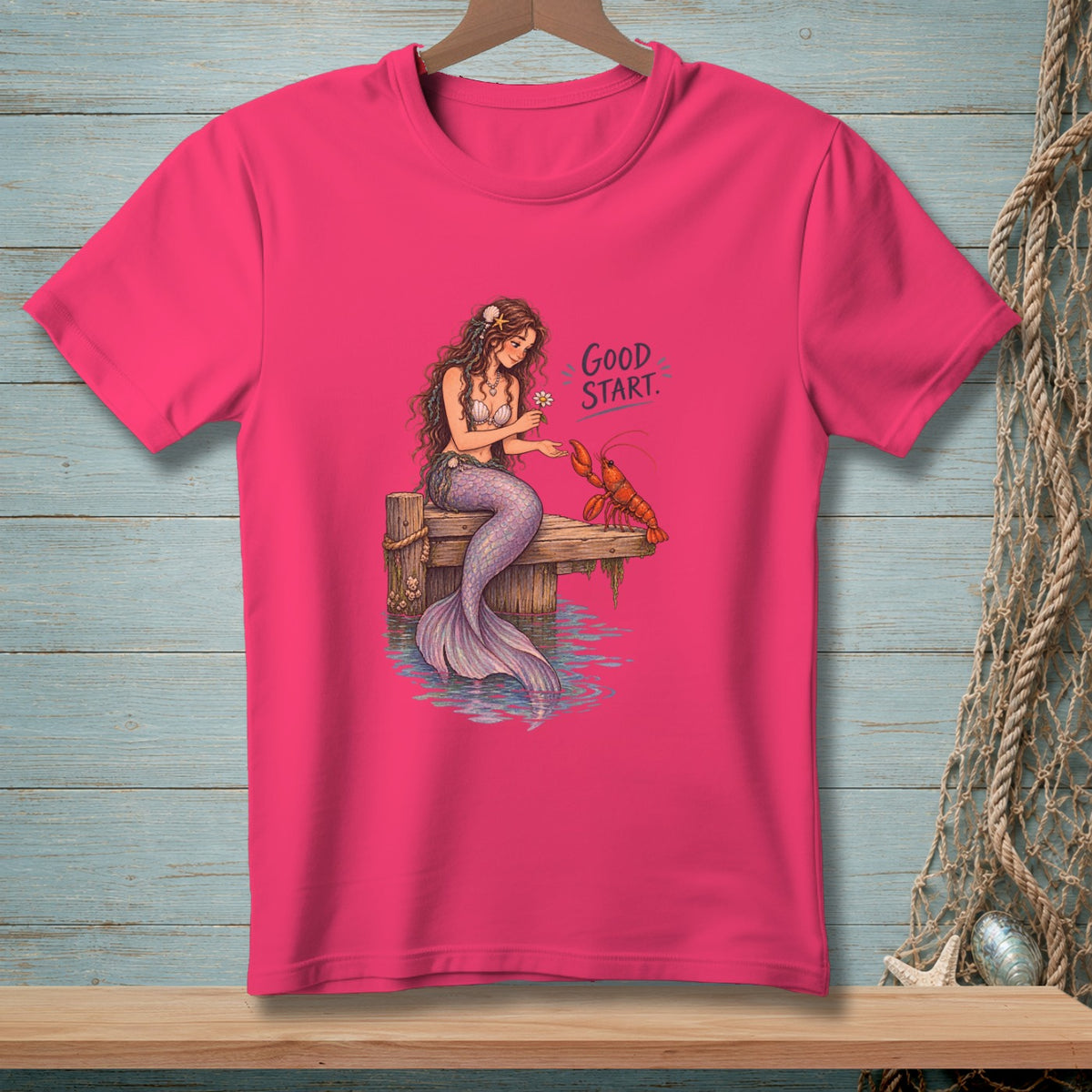 Pink t-shirt with illustration of mermaid and lobster with text "Good Start."