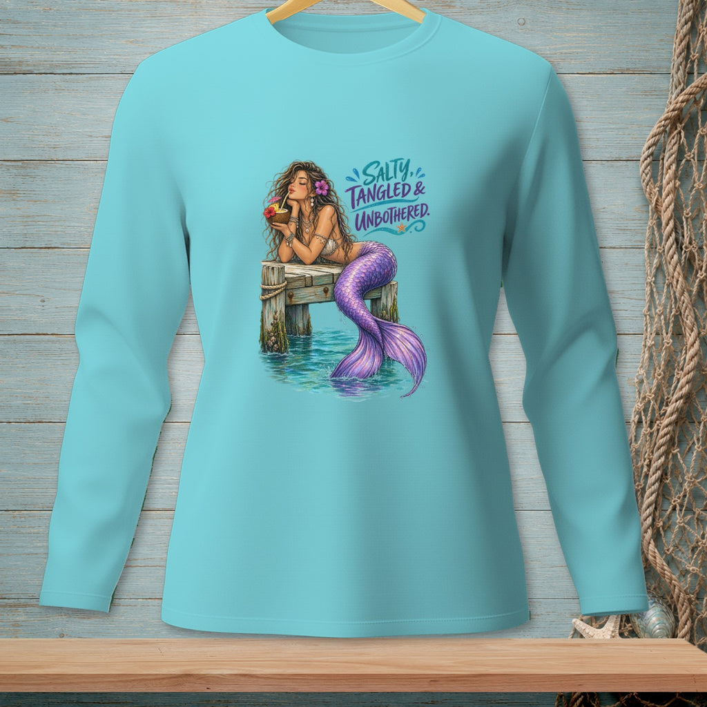 Mermaid with purple tail on a dock drinking from a coconut, with "Salty, Tangled & Unbothered" text.