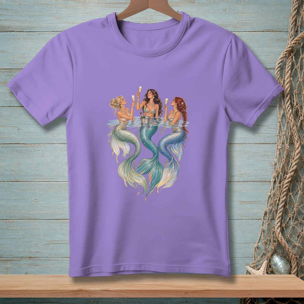 Three mermaids with champagne glasses in water, on a lavender t-shirt.